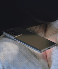 Close-up of a smartphone placed in the armchair.