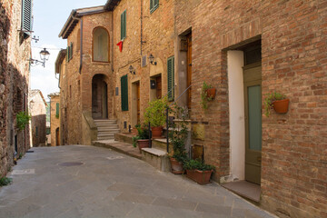 Fototapeta na wymiar A quiet residential street in the historic centre of the medieval town of Monticiano in Siena Province, Tuscany, Italy 