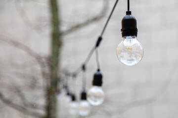 illumination on the street, electric bulbs on the wire. Lighting concept