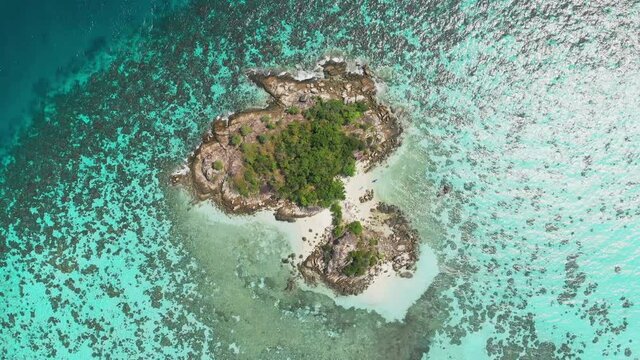 Aerial drone top down shot of desert lonely exotic tropical island near Koh Lipe on Andaman Sea in Thailand Full sun beautiful summer weather Social distancing Covid-19 Flying down with CCW rotation