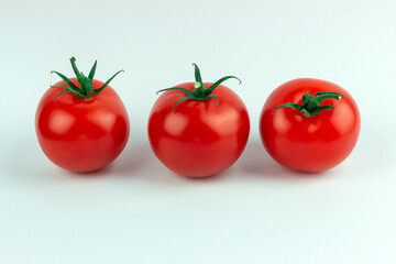 three red tomatoes isolated on white background, close up