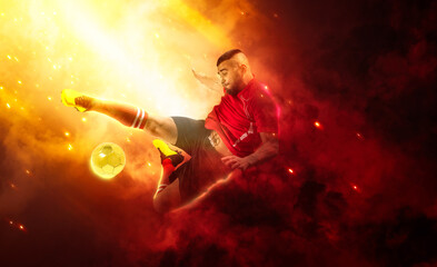 Fototapeta na wymiar Soccer player in action on smoke background