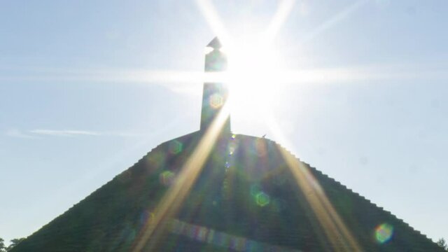 close up Time lapse of sun appearing behind obelisk on Austerlitz Pyramid. The Piramide van Austerlitz is a monument built in 1804 as a tribute to Napoleon Bonaparte.