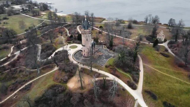 Aerial orbit shot of Flatow tower in Babelsberg Park, Potsdam during fall with flat light