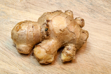 Ginger root on the wooden background. 
Top view.