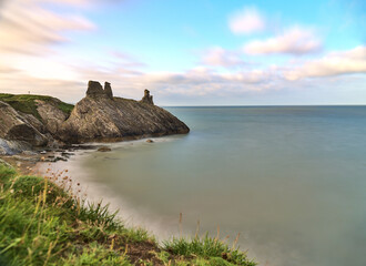 Stunning long exposure low ground view of seascape and Black Castle ruins along the Wicklow coastal line, South Quay, Corporation Lands, Co. Wicklow, Ireland