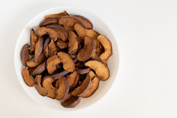 Slices of sun dried fruits dehydrated apples on white background.