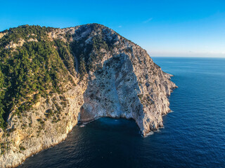 Aerial drone view over western Alonnisos towards Skopelos island at sunset. Natural landscape, beautiful rocky scenery, in Sporades, Aegean sea, Greece