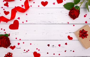 Gift, rose and red hearts on wooden background