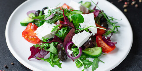 Greek salad vegetables and feta cheese portion on the table for healthy meal snack outdoor top view copy space for text food background rustic image keto or paleo diet