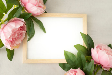 Blank frame to write your text with pretty peonies and green leaves. Perfect for love message