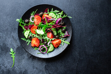 vegetable salad tomato, arugula, lettuce, olives vegetables fast food ready to eat portion on the table for healthy meal snack outdoor top view copy space for text food background rustic image keto