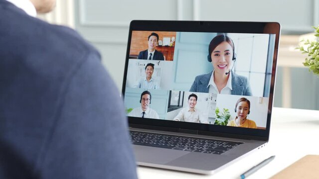 Young Asian businessman work at home and virtual video conference meeting with colleagues business people, online working, video call at home office