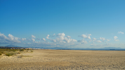 Big golden sand beach at sunny day. Minimalist coastal panorama of a large empty beach