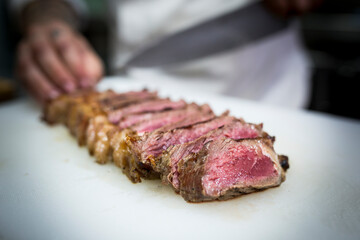 Chef cutting meat in the kitchen