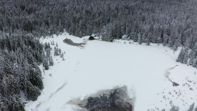Frozen lake in winter, woods covered in fresch snow, aerial view, Crno jezero, Black lake, Pohorje, Slovenia