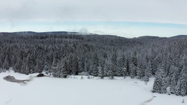 Frozen lake in winter, woods covered in fresch snow, aerial view, Crno jezero, Black lake, Pohorje, Slovenia