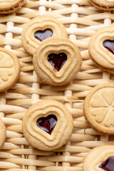 Close-up of heart-shaped cookies and strawberry jam, on a basket, for Valentine's Day, in vertical