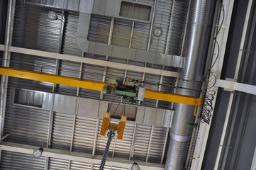 The roof of an industrial enterprise. Ventilation, crane beam, lighting.
