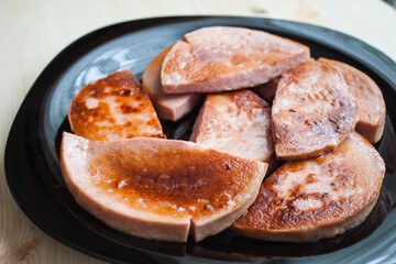 Christmas grilled sausages with spices on a stone background with Christmas trees and Christmas decorations, gifts