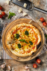 Italian pizza margarita with pesto sauce.