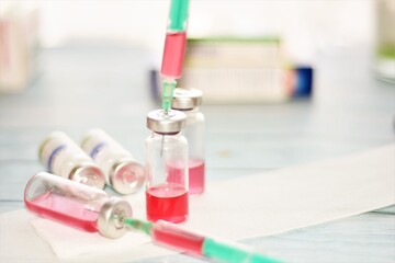 syringes and vaccine in glass ampoules