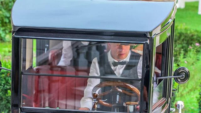 Man parks a vintage Ford Model T car for a wedding party outdoor