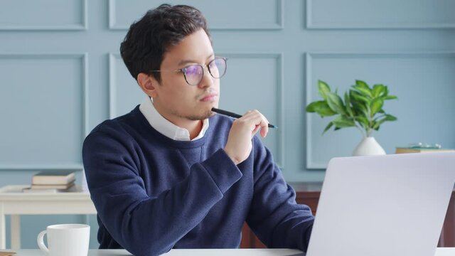 Young asian businessman using computer laptop, idea thinking and inspiration concept