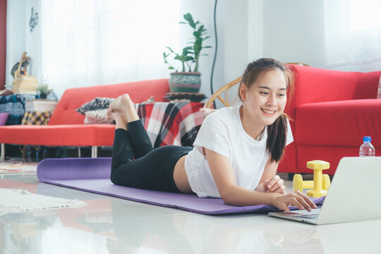 Happy woman open online tutorial on computer laptop for her exer