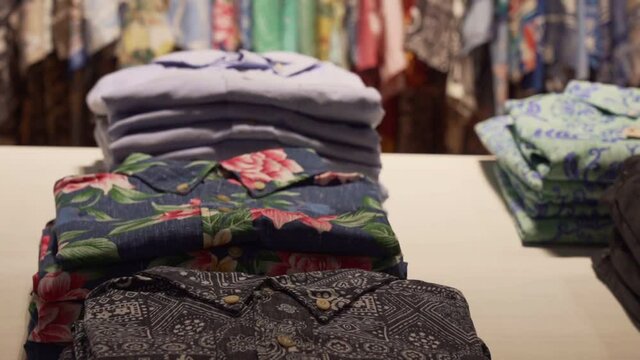 Colourful Hawaiian Shirts on display on wardrobe store in Oahu Island, Hawaii - Tilt up Close up shot