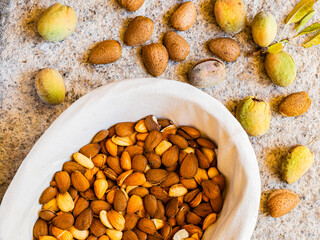 Overhead shot of a basket of freshly picked and peeled almonds.