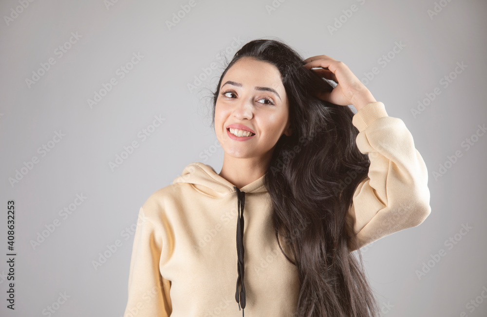 Wall mural young woman hand in long hair