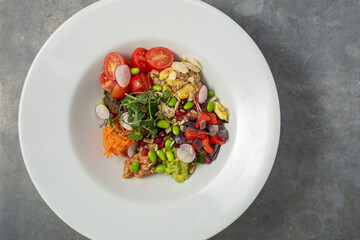 Mixed bean poke bowl salad with raddish, tomato, snap peas, green beans