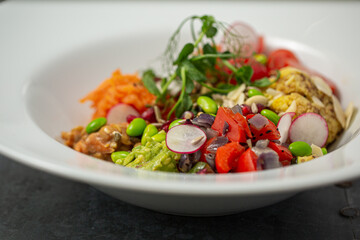Mixed bean poke bowl salad with raddish, tomato, snap peas, green beans