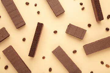 Chocolate wafers with coffee on beige background
