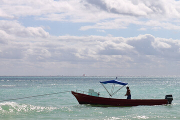 Artisanal fisherman preparing his boat before going out to catch the day. traditional form of fishing in the Caribbean for family sustenance and to transport tourists