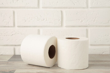 Roll of toilet paper on light background, top view. Space for text