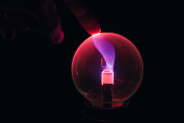 hand touches the plasma ball. electrical impulses, living electricity