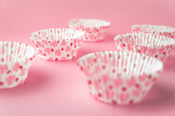 empty pink cupcake mold with hearts on a pink background. Valentine's Day