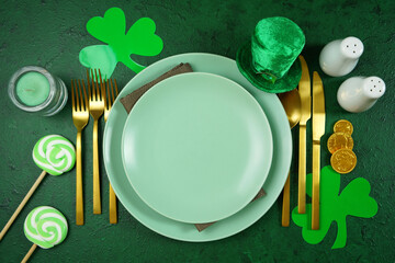Happy St Patrick's Day plates table setting, styled with leprechaun hat, shamrocks, and chocolate...