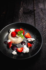 Vanilla Panna Cotta served with fresh Rutland strawberries, meringue shards and raspberry coulis
