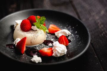 Vanilla Panna Cotta served with fresh Rutland strawberries, meringue shards and raspberry coulis