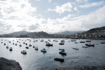 bay on the coast of biscay with fishing boats in the background