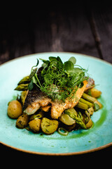 Seared sea-bass fillet with sautéed spring onions and parsley potatoes, buttered asparagus, chilli, garlic and coriander butter