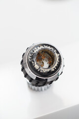 Old faucet aerator close-up on a white background. Broken sink mixer