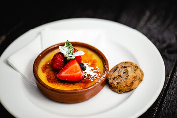 Lemon Creme Brule topped with summer berries, served with a dark chocolate shortbread