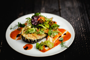 Couscous stuffed, baked aubergine topped with cheddar, served with a dressed baby leaf salad