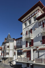 Fototapeta na wymiar Traditional red and white Basque houses - typical architecture of Saint Jean de Luz, Pyrenees-Atlantiques department in southwestern France.