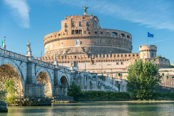 Fototapeta na wymiar Rome, Italy - October 9, 2019 - View of the old bridge, sculptures of angels and the Castel Sant'Angelo against the blue sky