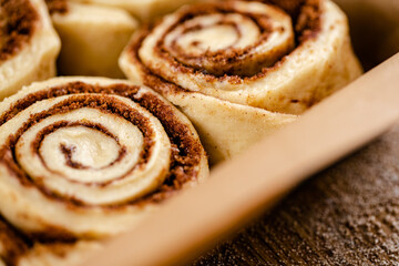 Raw cinnamon roll dough being prepared ready for baking